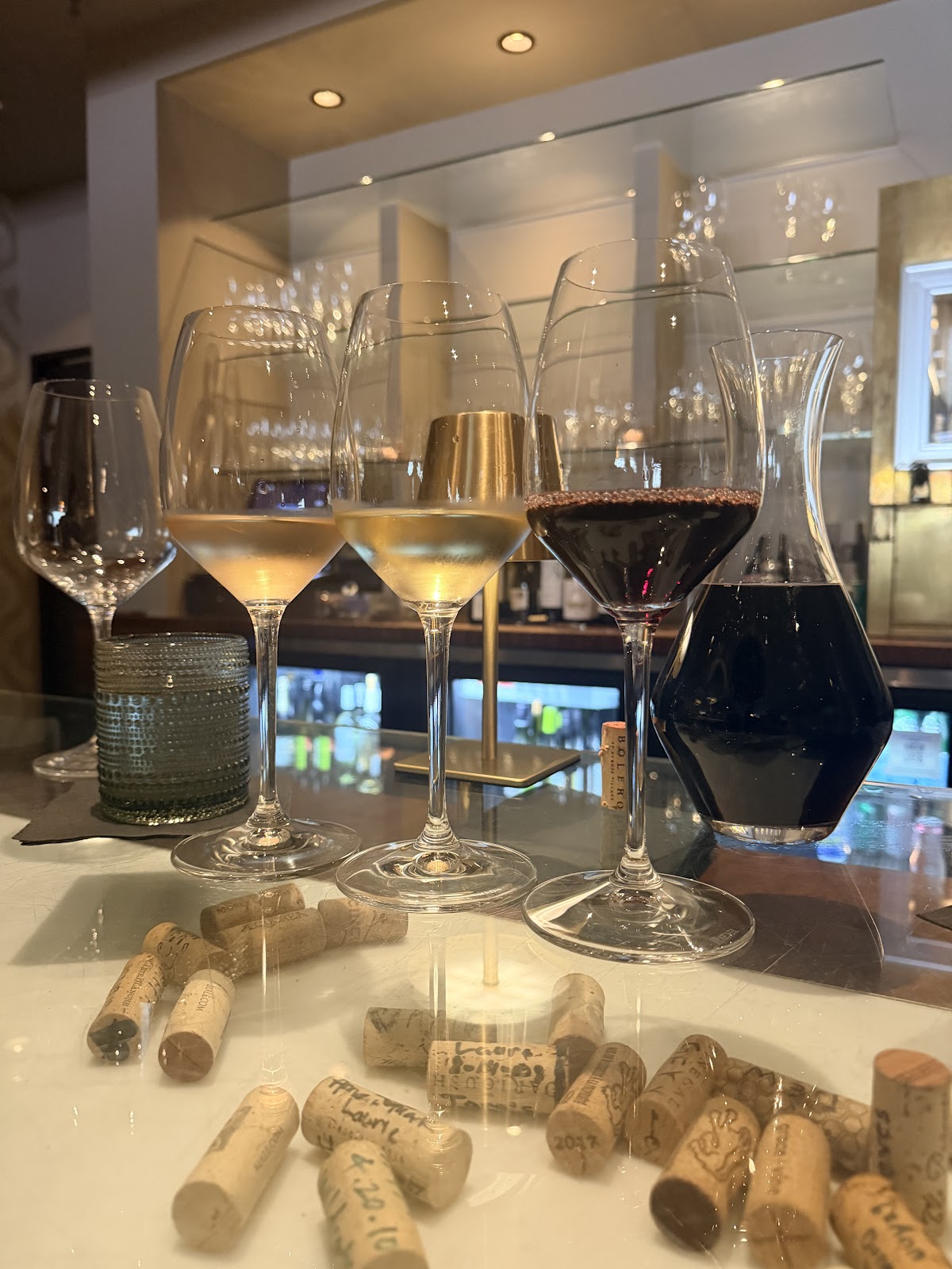 Stemware of white, rose and red wines beside a decanter at the Wineworks bar
