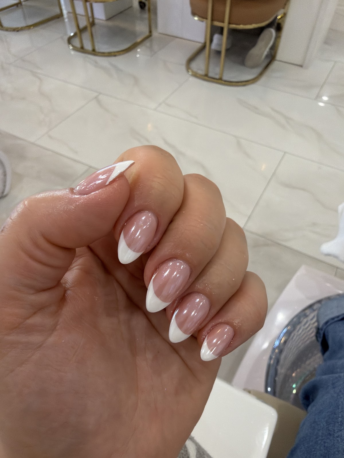 Soft almond French manicure against the white marble of Zen Nail Lounge
